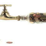 Money coins fall out of the golden tap